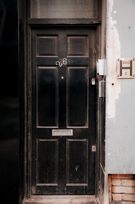 Dark door with number 26 representing professional access and heritage