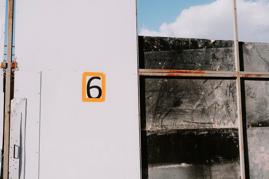 Stenciled 6 on white wall representing clean support center environment