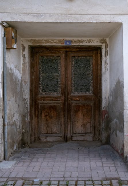 Old wooden door with 6 representing legacy entry plans